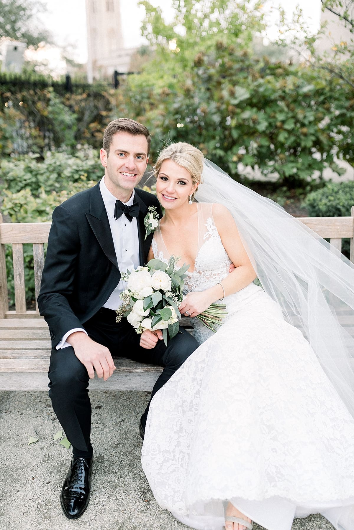 Arielle Peters Photography | Bride and groom sitting on a bench in downtown Indianapolis on wedding day.
