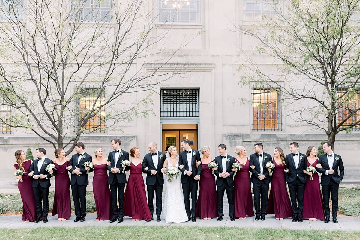 Arielle Peters Photography | Bride and groom and wedding party looking at each other in downtown Indianapolis on wedding day.