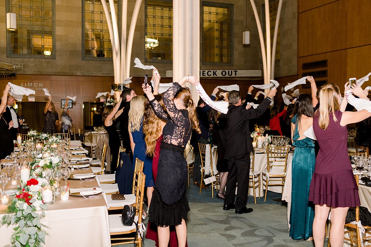 Arielle Peters Photography | Wedding guests cheering loudly as bride and groom enter their wedding reception at the Indy Public Library.