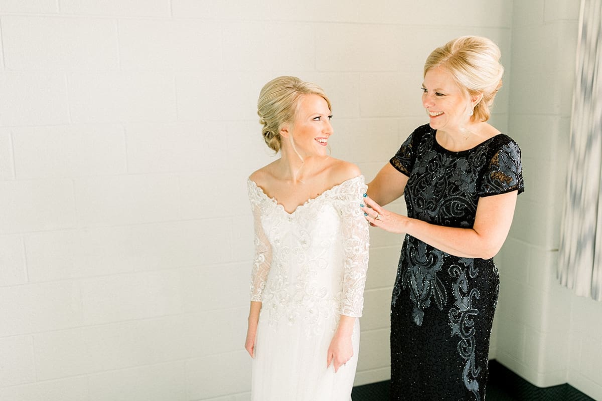 Arielle Peters Photography | Mother of the bride smiling at the bride in her dress on her wedding day.