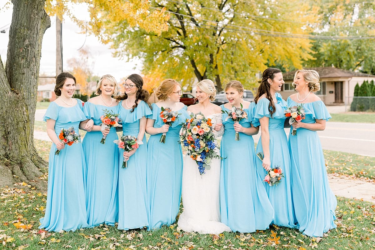 Arielle Peters Photography | Bride and bridesmaids smiling outside on fall wedding day.