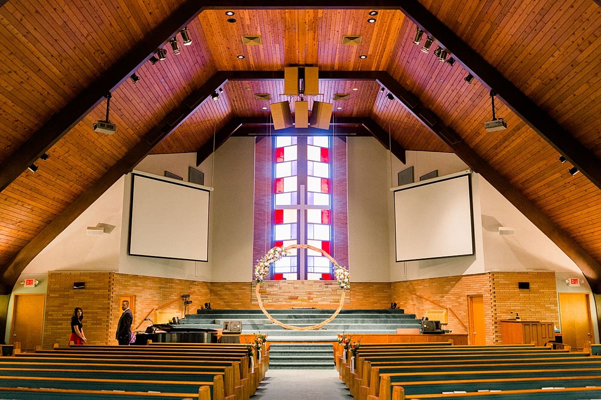 Arielle Peters Photography | Interior of wood church with stained glass window on fall wedding day.