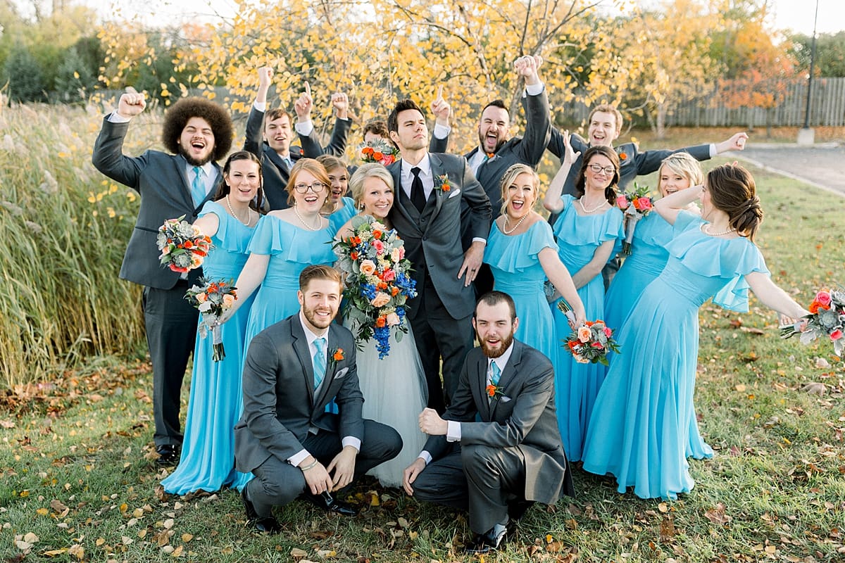 Arielle Peters Photography | Bride and groom cheering with wedding party outside on fall wedding day.