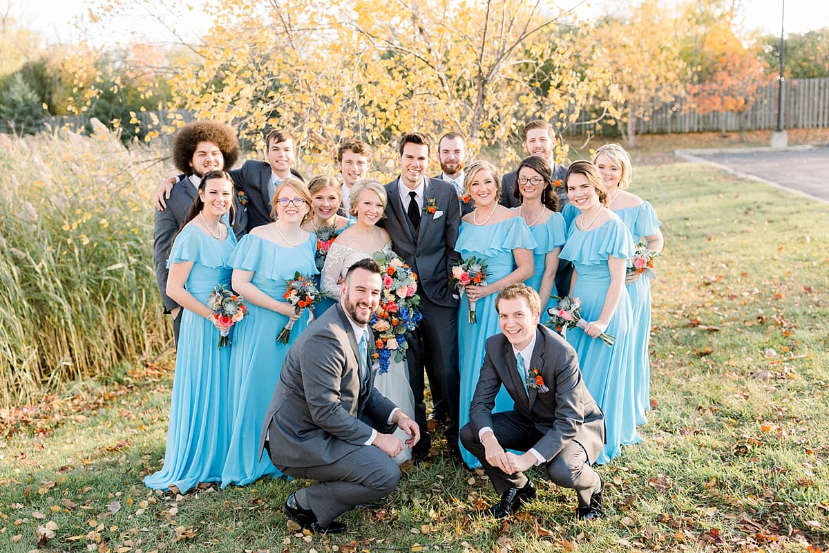 Arielle Peters Photography | Bride and groom smiling with wedding party outside on fall wedding day.