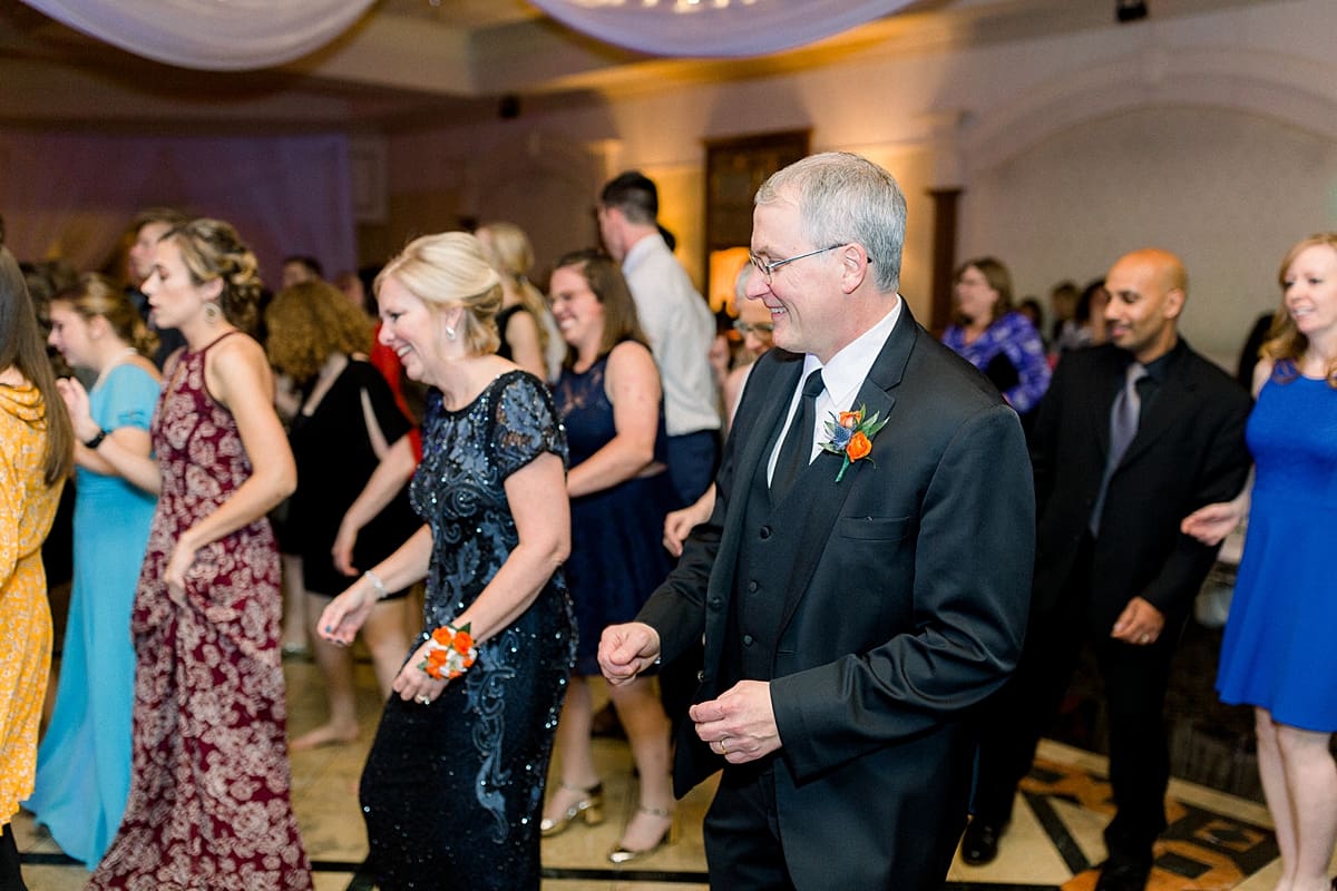 Arielle Peters Photography | Wedding guests line dancing and having fun at fall wedding reception.