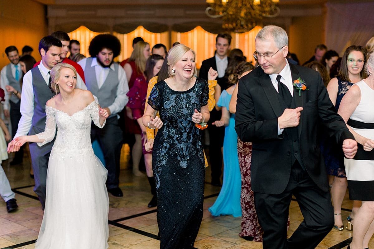 Arielle Peters Photography | Bride and groom line dancing with parents and laughing at fall wedding reception.
