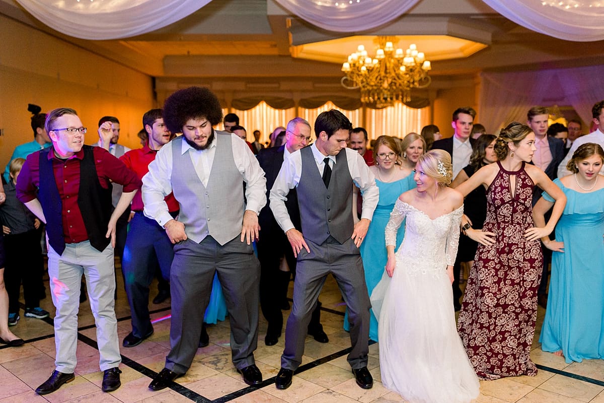 Arielle Peters Photography | Bride and groom line dancing with guests at fall wedding reception.