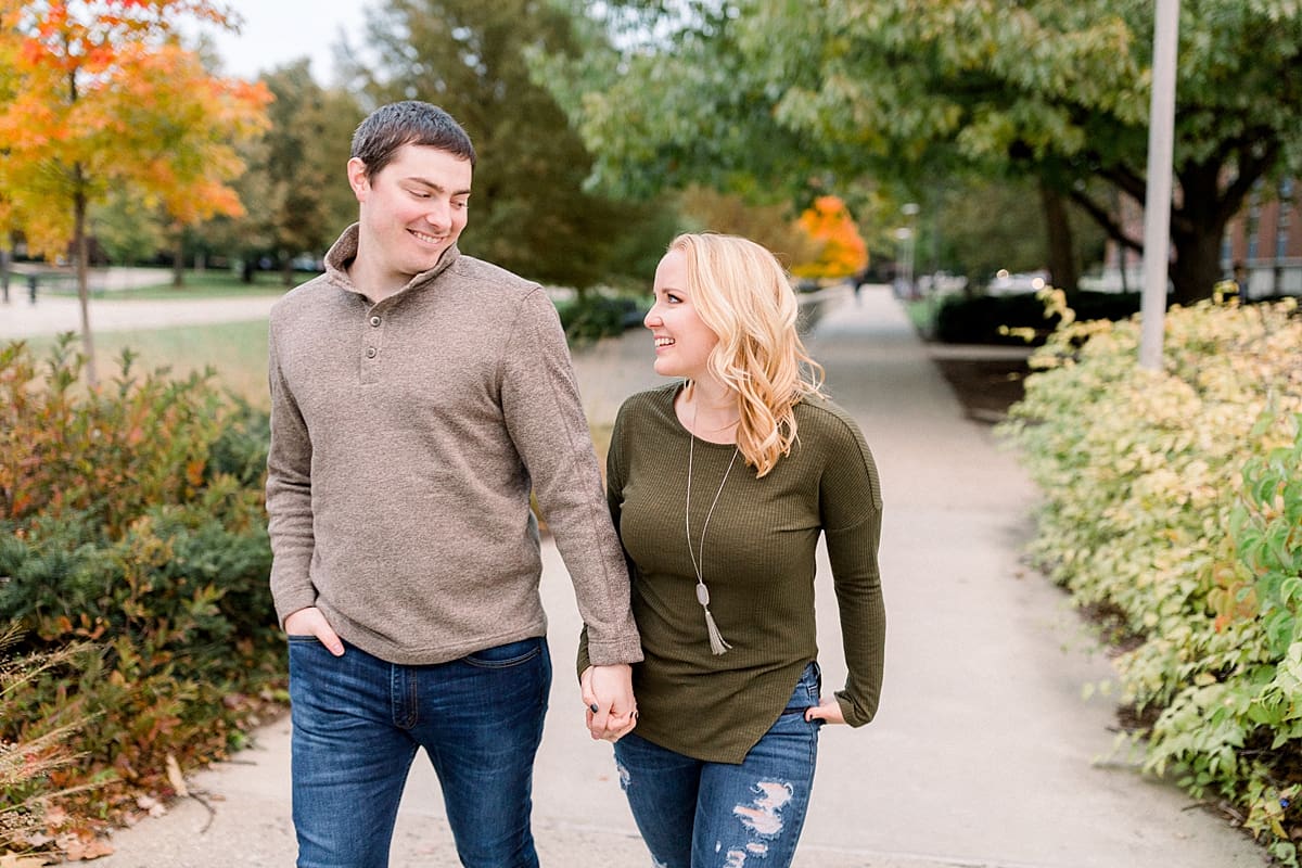 Arielle Peters Photography | Couple holding hands and taking fall engagement photos at Purdue University.