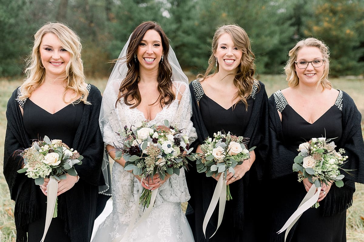 Arielle Peters Photography | Bride with bridesmaids in field on wedding day.