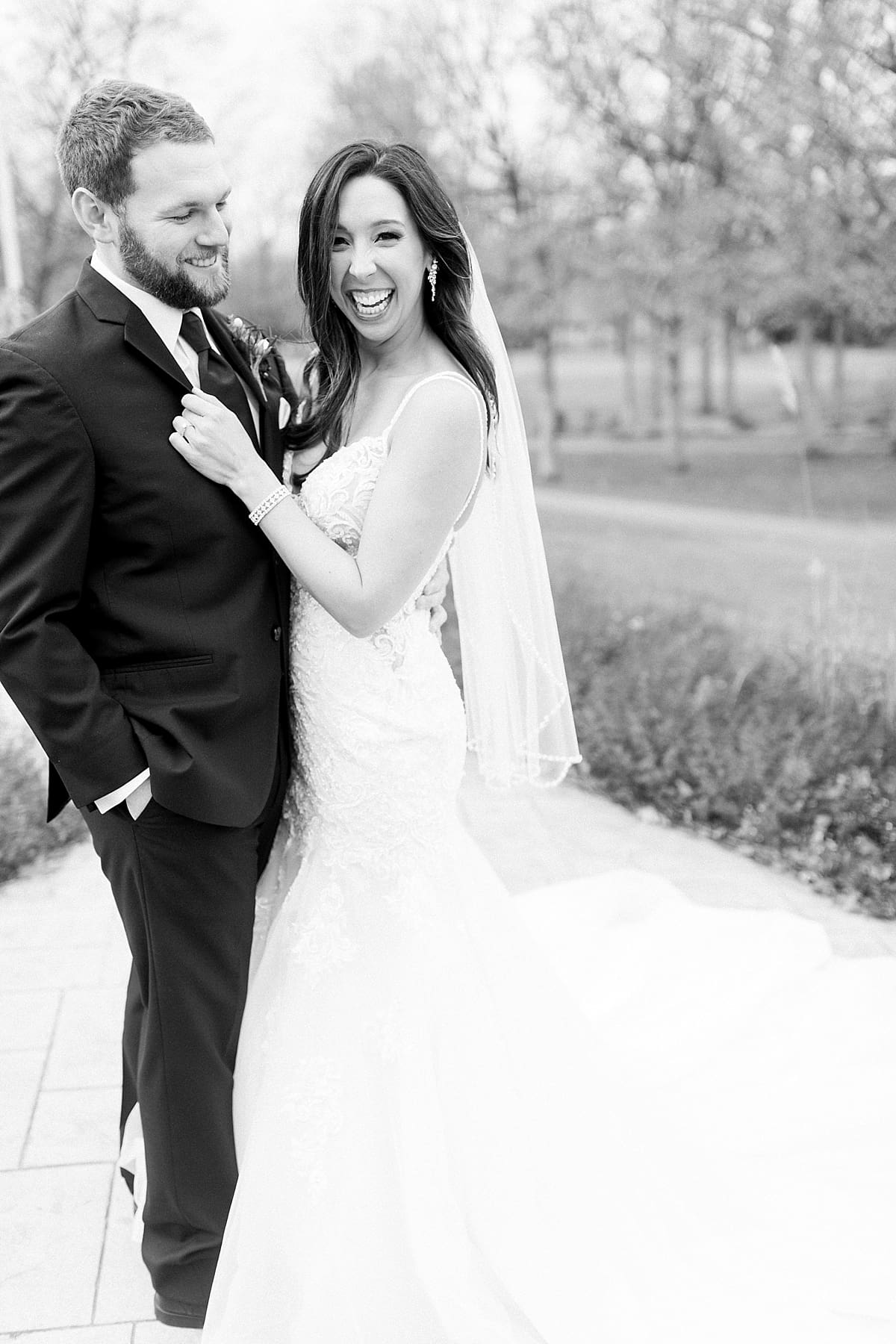 Arielle Peters Photography | Bride and Groom laughing at a golf course on wedding day.