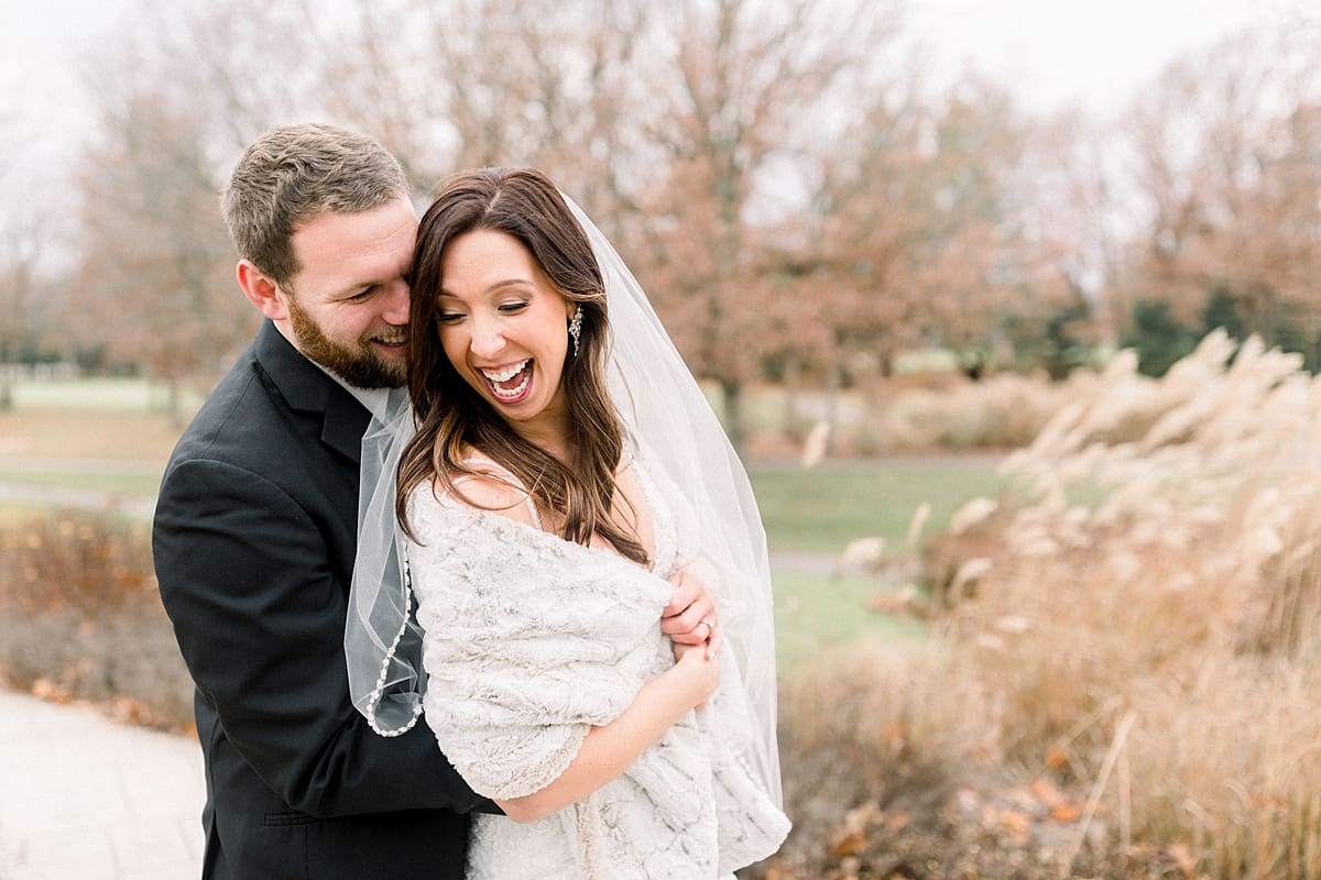 Arielle Peters Photography | Bride and Groom laughing together at golf course on wedding day.