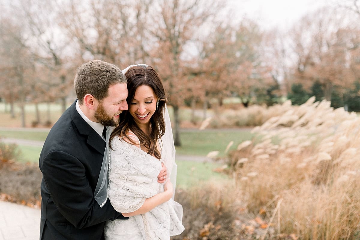 Arielle Peters Photography | Bride and Groom hugging at golf course on their wedding day.