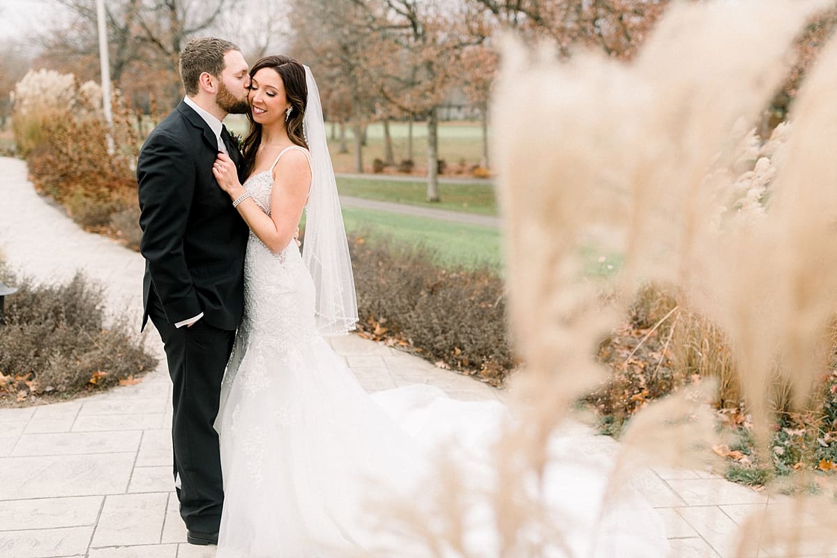 Arielle Peters Photography | Bride and Groom kissing at golf course on wedding day.