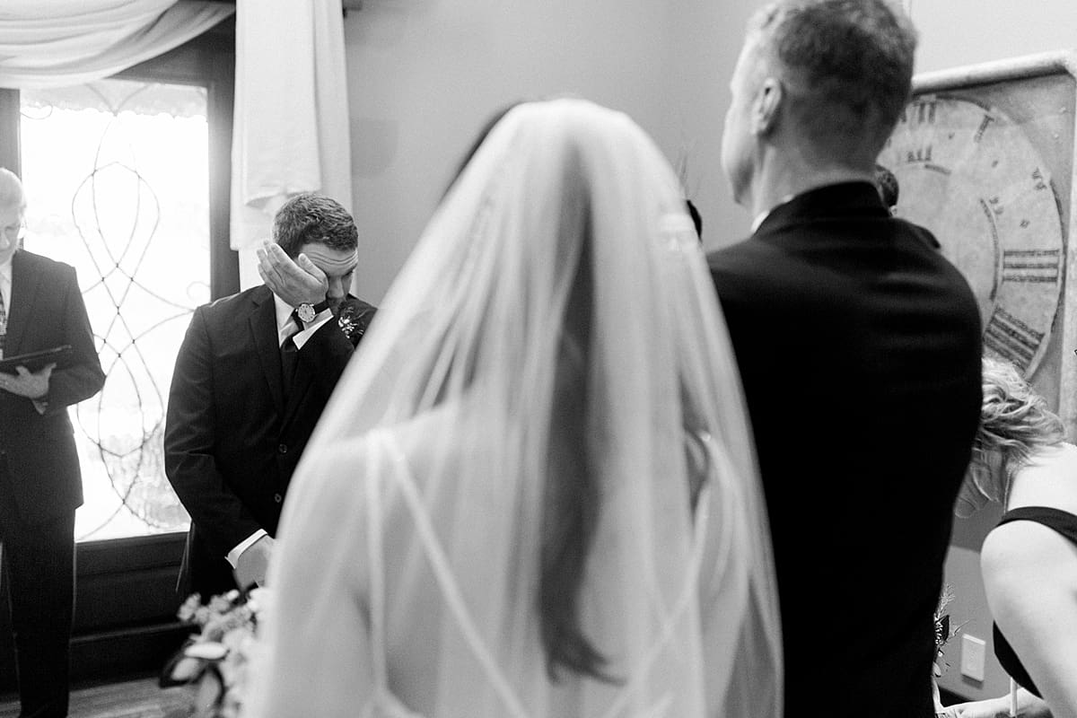 Arielle Peters Photography | Bride walking down the aisle and groom crying of happiness on wedding day.