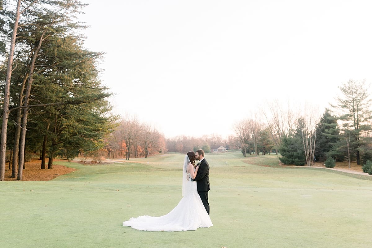 Arielle Peters Photography | Bride and Groom kissing on golf course on wedding day.