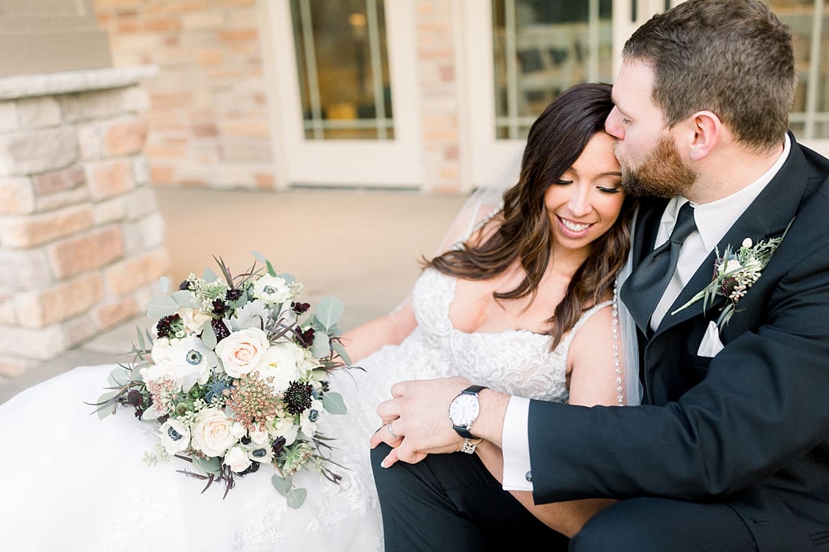 Arielle Peters Photography | Bride and Groom kissing at golf course on their wedding day.