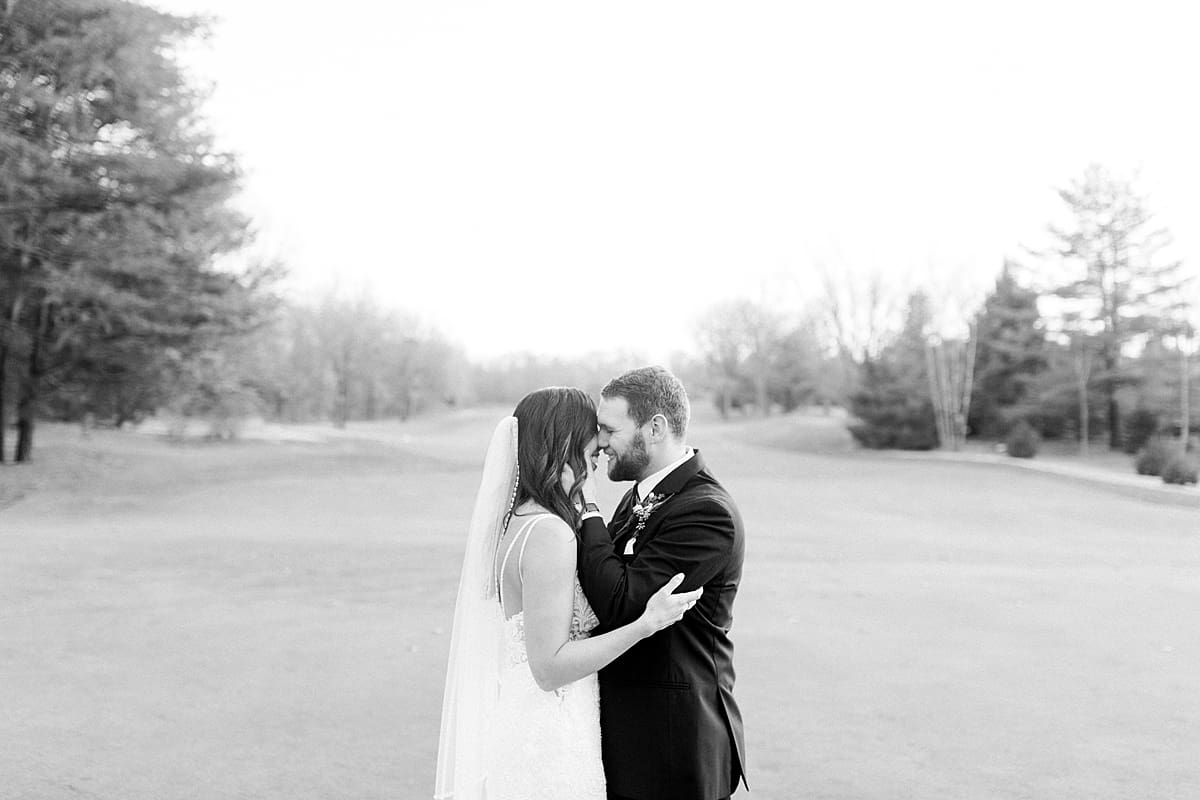 Arielle Peters Photography | Bride and Groom kissing on golf course on wedding day.