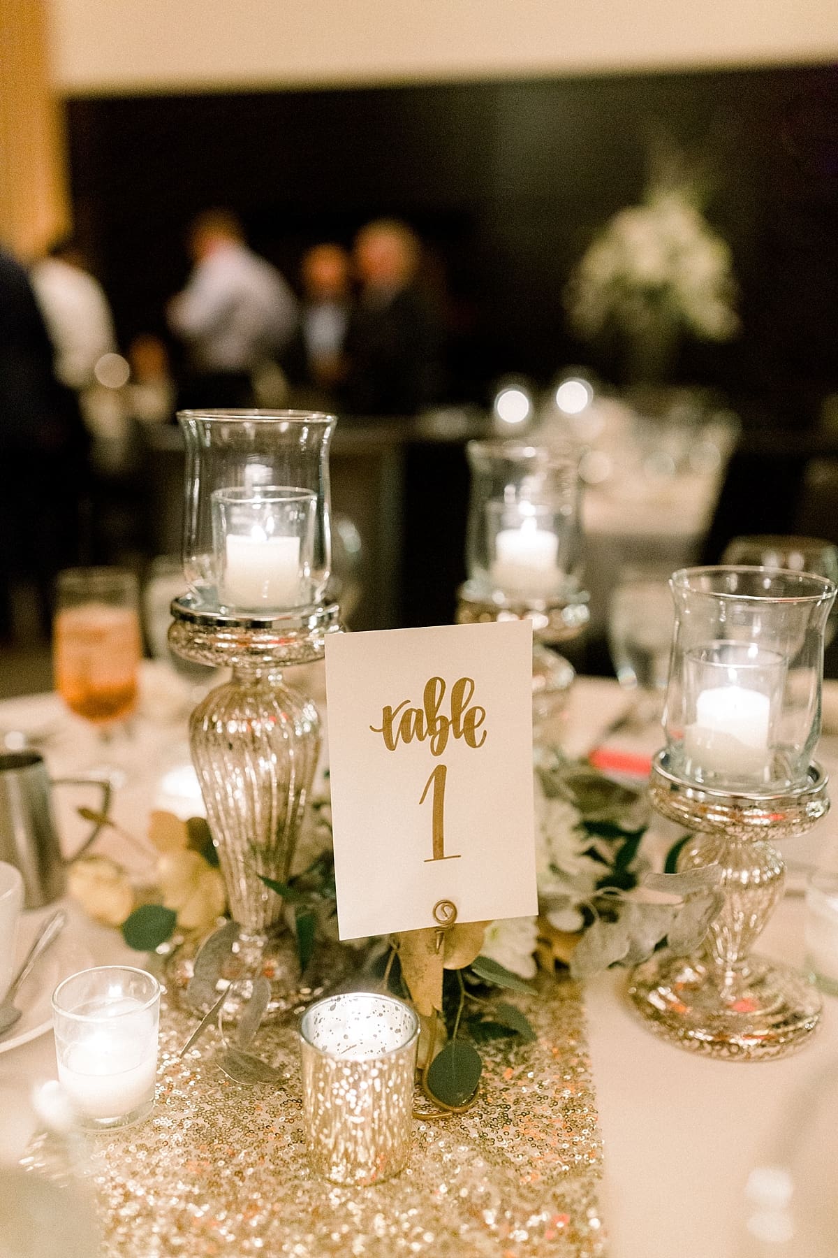 Arielle Peters Photography | Wedding centerpieces and table numbers with candles in reception hall.