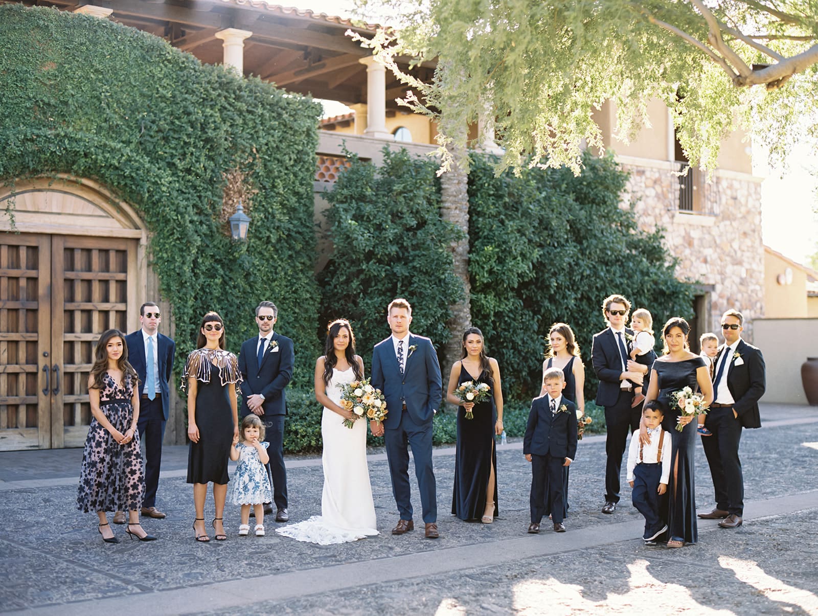 Bride and groom posing for photos with their wedding party at Blackstone Country Club in Peoria, Arizona