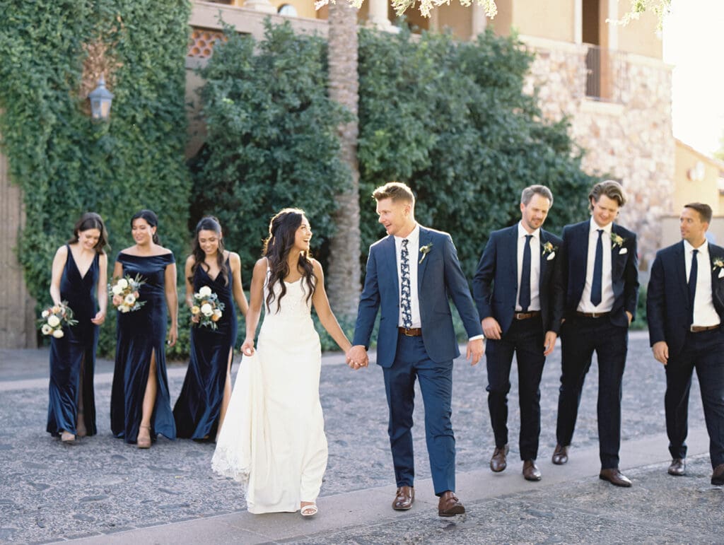 Bride and groom posing for photos with their wedding party at Blackstone Country Club in Peoria, Arizona