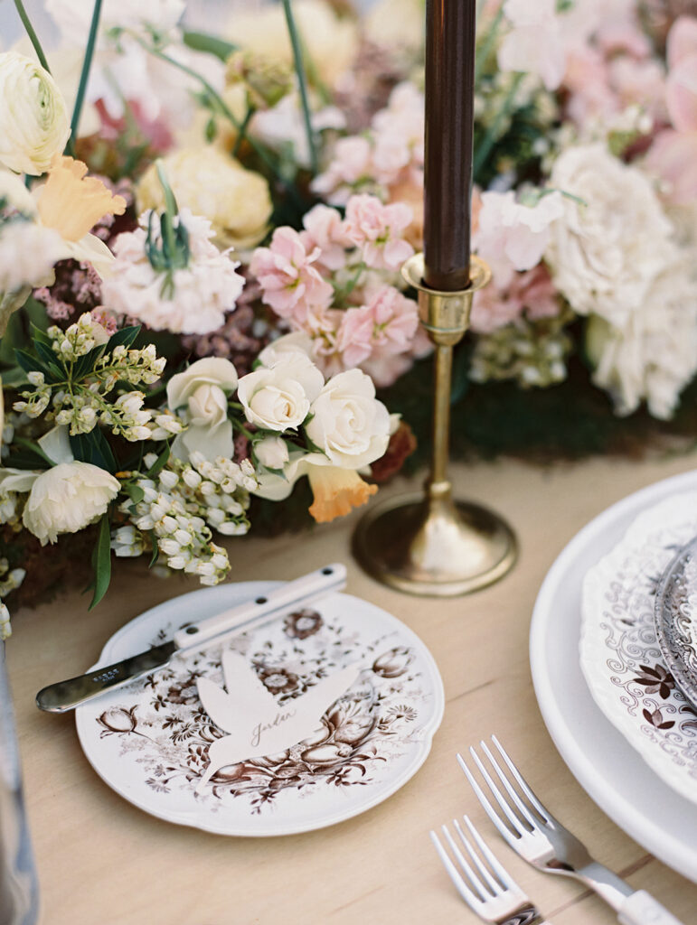 Wedding reception tables with florals by LB Floristry, candles by Applewood Candles Co, and rentals from PR Rentals, and linens from BBJ La Tavola,