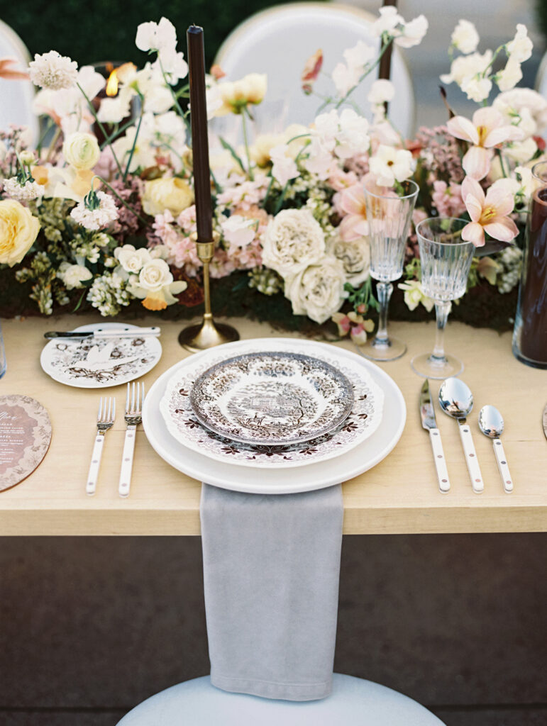 Wedding reception tables with florals by LB Floristry, candles by Applewood Candles Co, and rentals from PR Rentals, and linens from BBJ La Tavola,