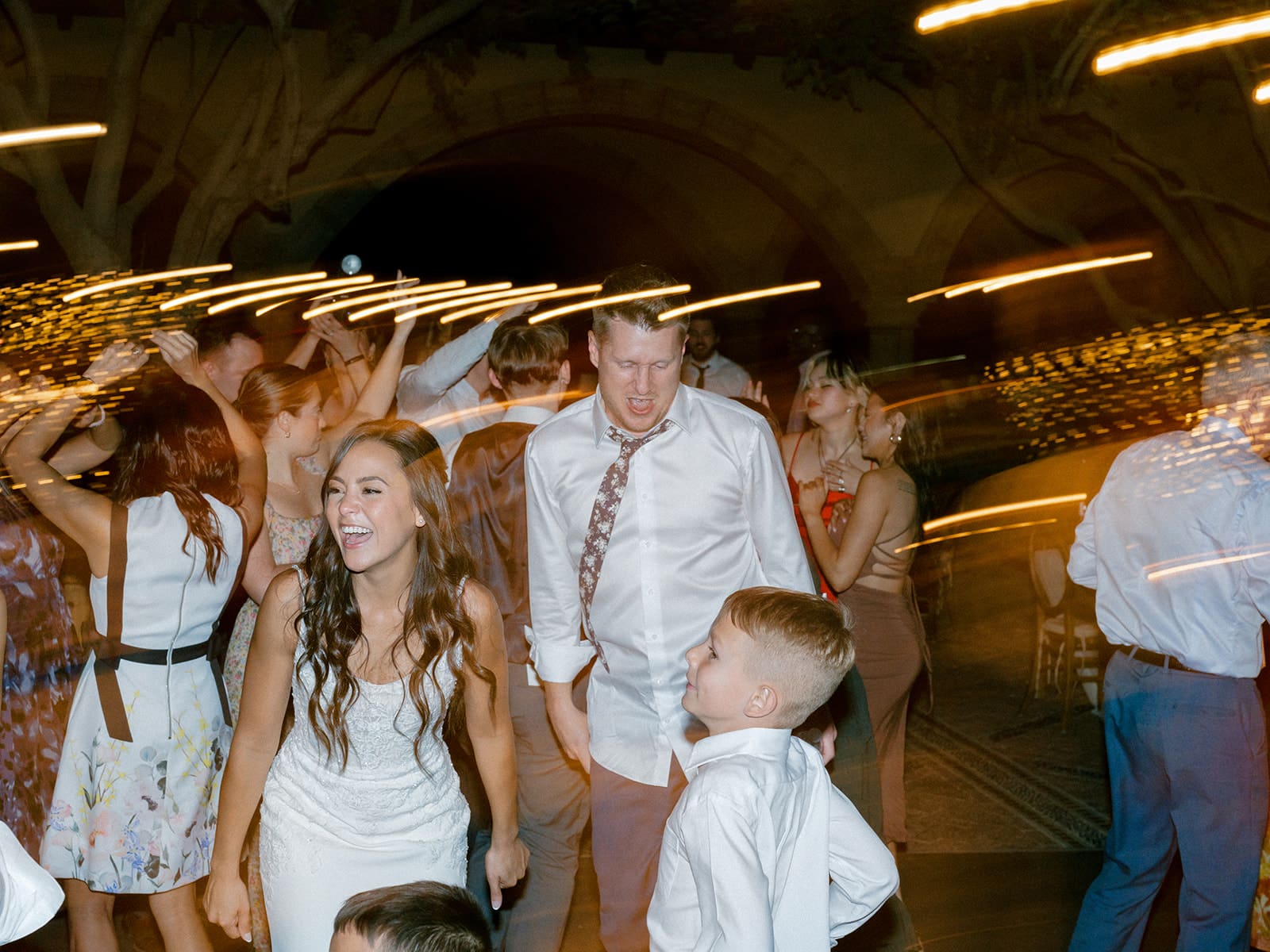 Bride, groom and their sun dancing during their wedding reception