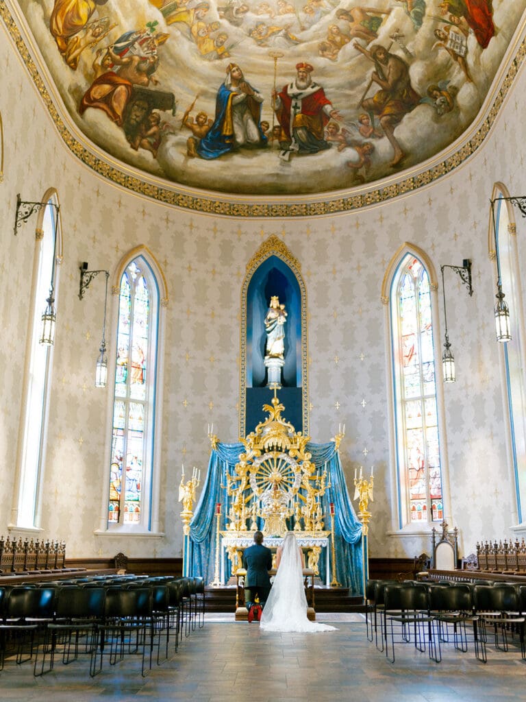 An indoor Catholic wedding ceremony at Basilica of the Sacred Heart in Indiana