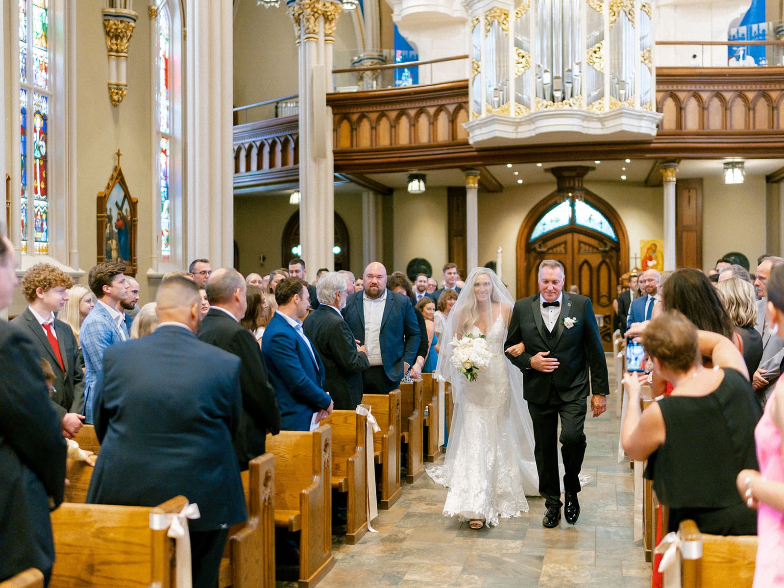 An indoor Catholic wedding ceremony at Basilica of the Sacred Heart in Indiana