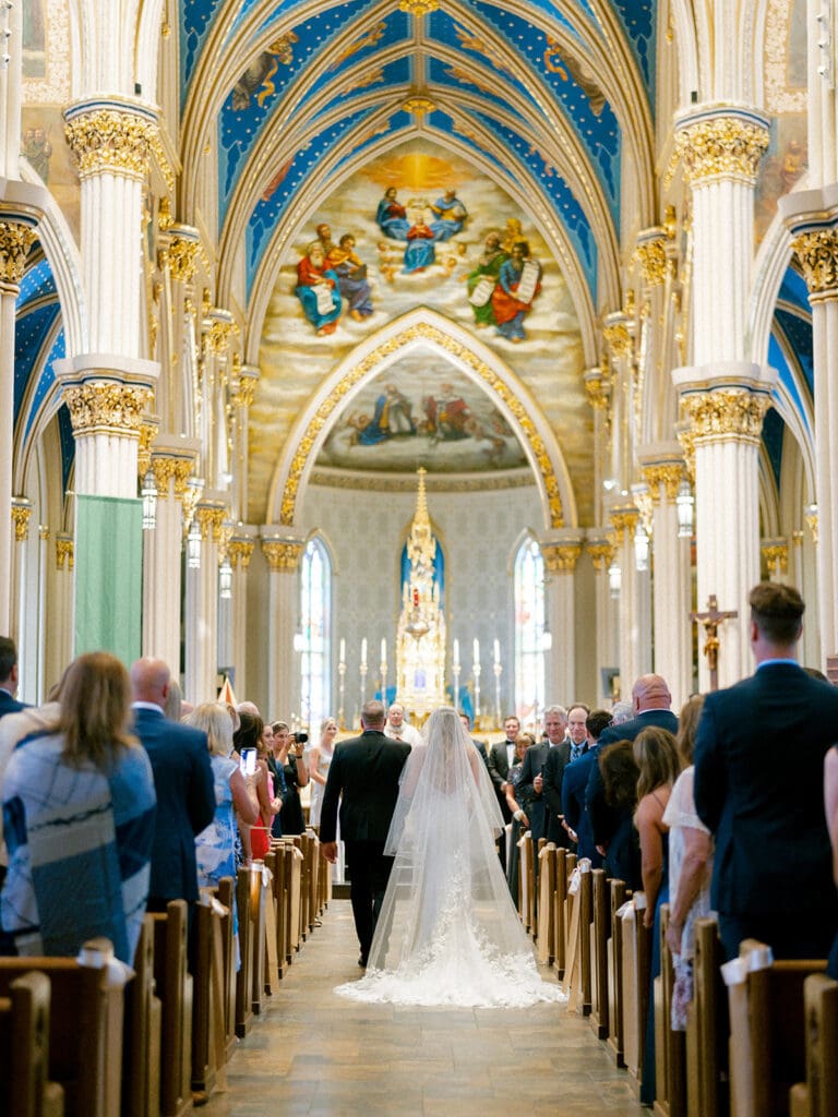 An indoor Catholic wedding ceremony at Basilica of the Sacred Heart in Indiana
