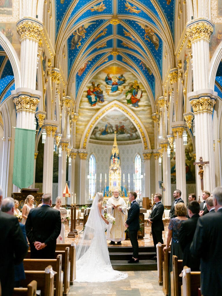 An indoor Catholic wedding ceremony at Basilica of the Sacred Heart in Indiana