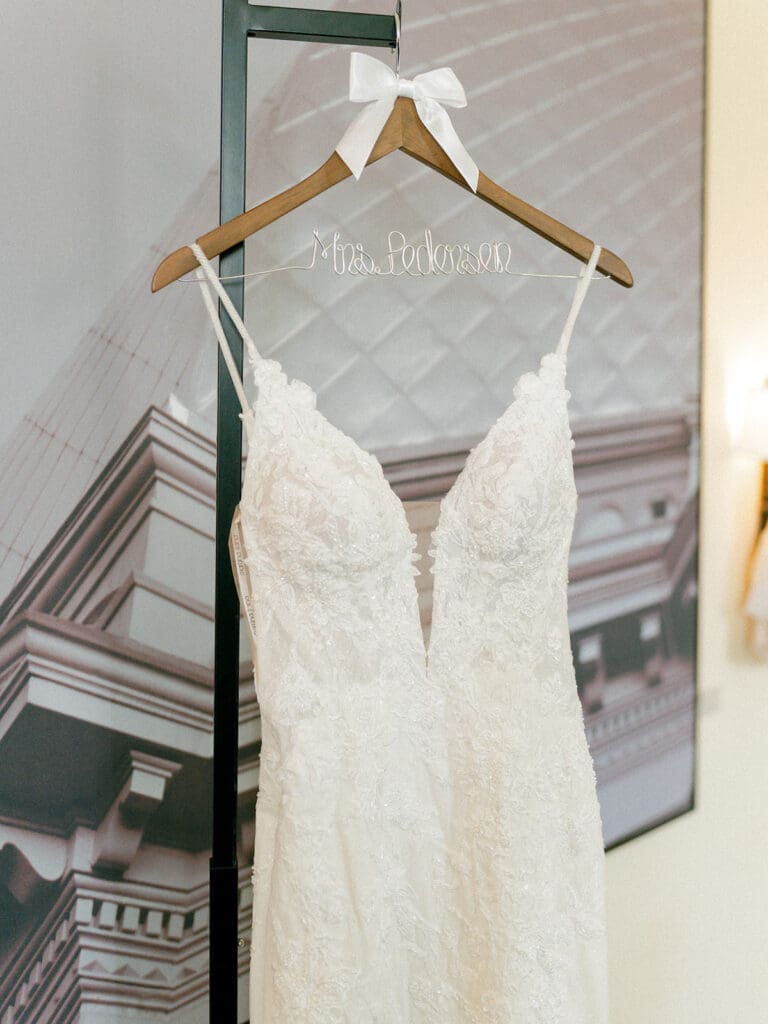 An elegant v-necklined wedding dress with a custom name hanger