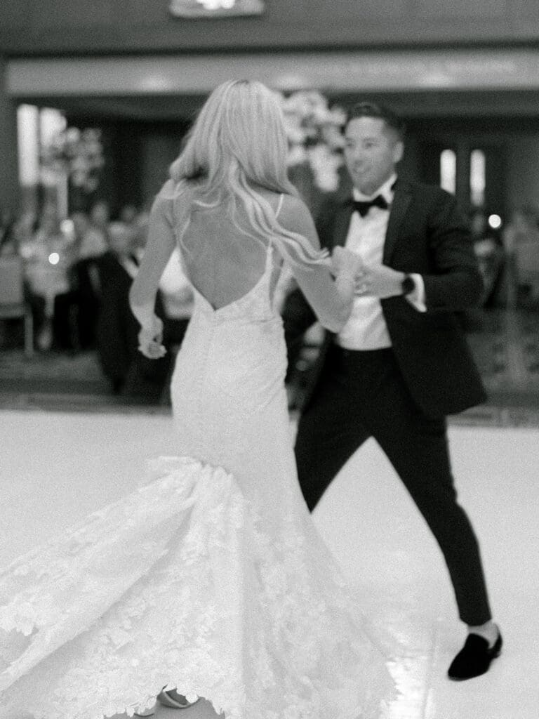 Black and white photo of a bride and groom sharing their first dance