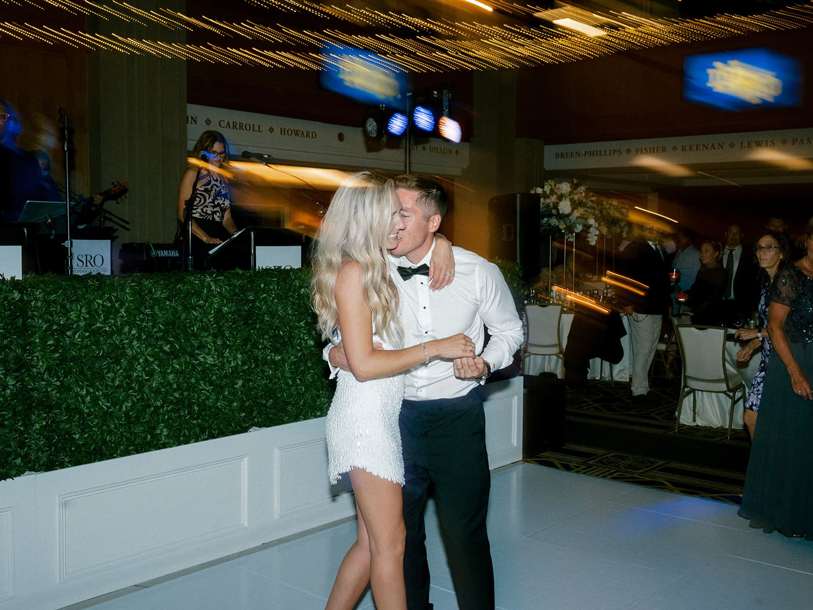 Groom kissing his bride during their wedding reception