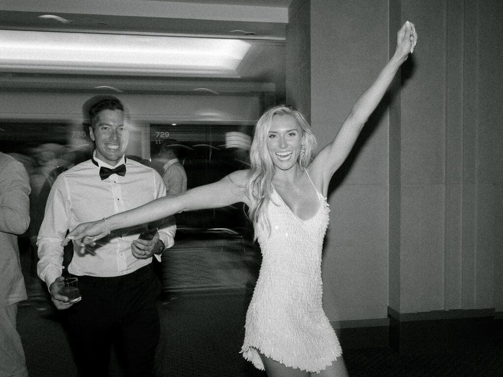 Black and white photo of a groom and bride dancing during their Notre Dame wedding reception