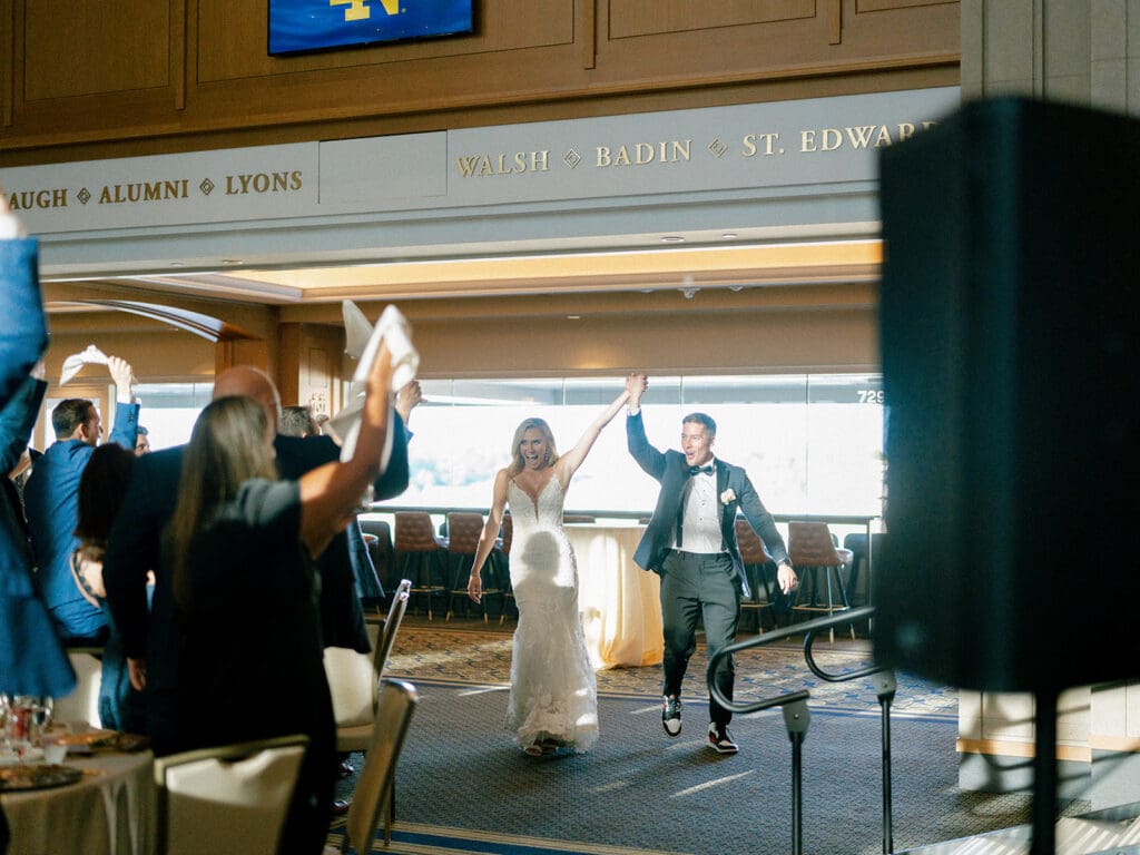 Bride and groom entering their Notre Dame wedding reception in Dahnke Ballroom