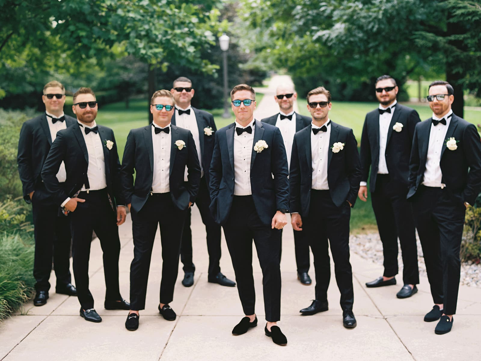 Groom and groomsmen portraits while wearing sunglasses from an elegant summer Notre Dame wedding in Indiana