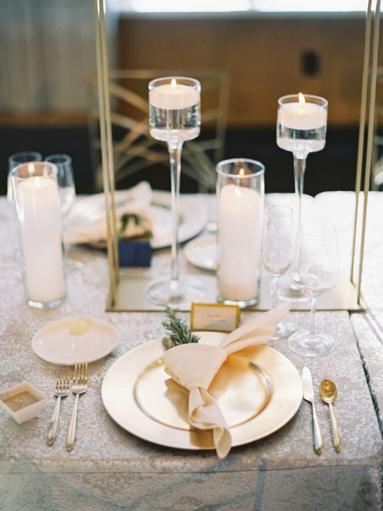An indoor Notre Dame wedding reception in Dahnke Ballroom with gold and white accents and white florals