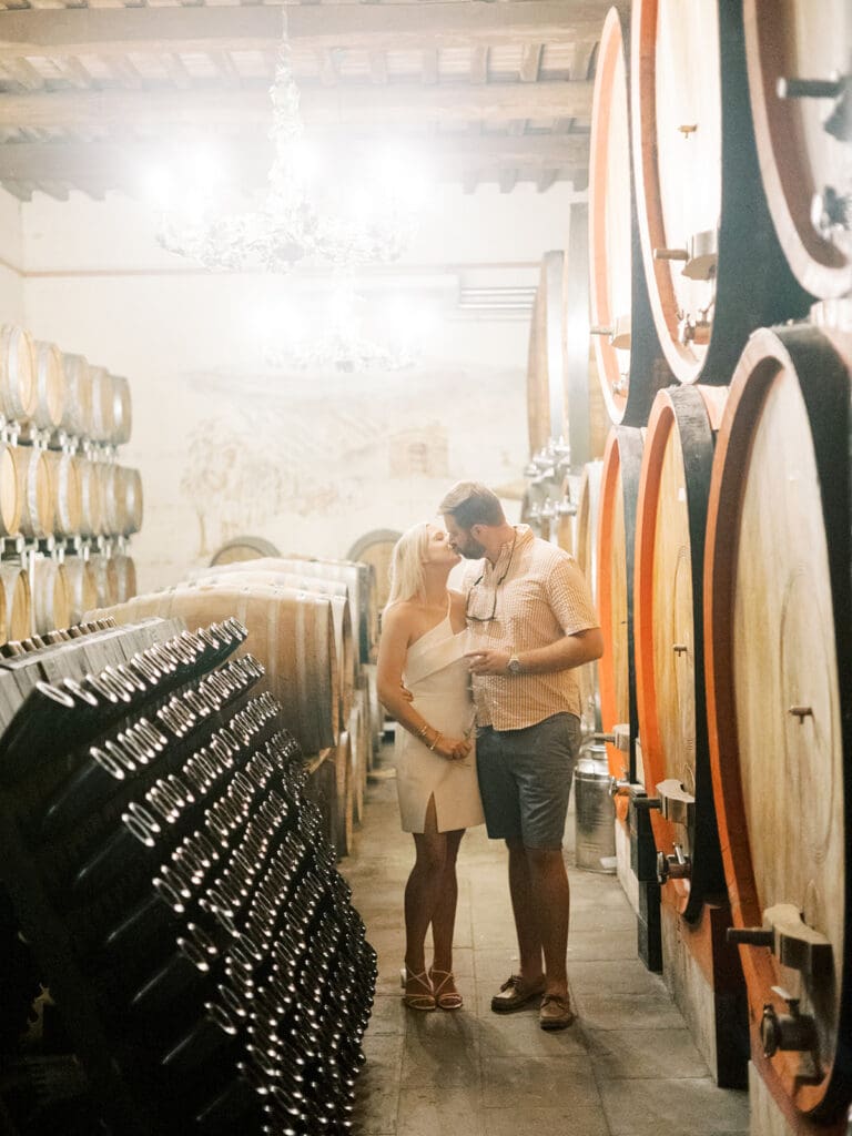 Bride and groom kissing at Poggio Molina winery for a wine tasting night