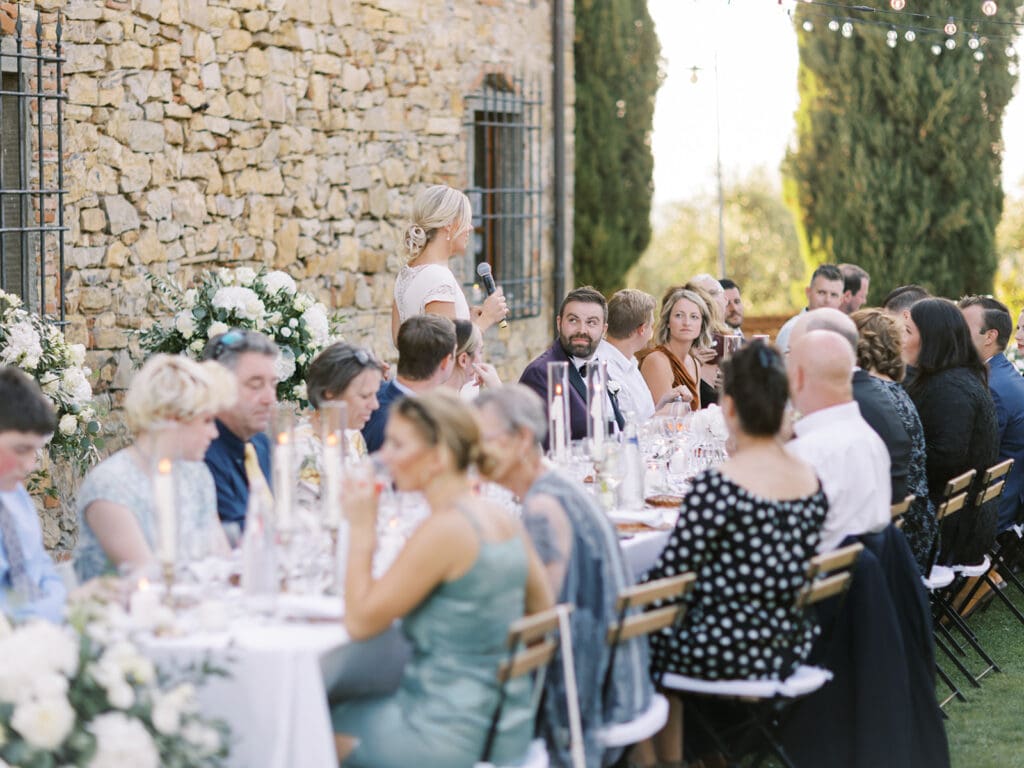 Bride giving a speech during their outdoor summer wedding reception