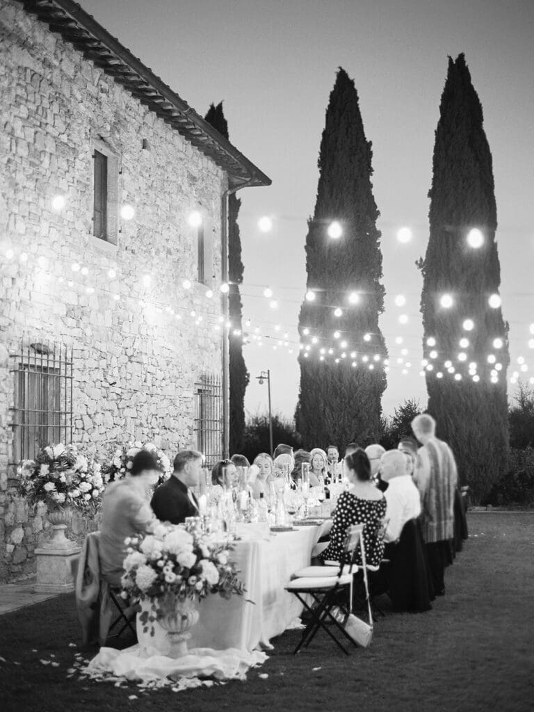 Black and white photo of an outdoor summer wedding reception at Villa Petrea in Italy