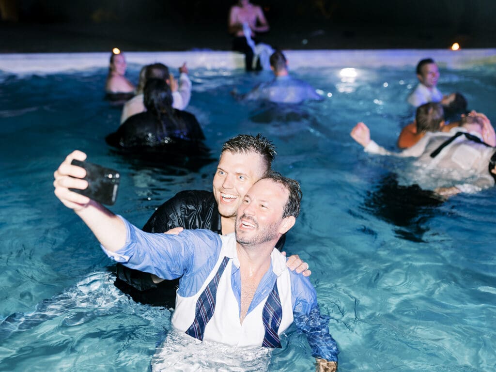 Wedding guests taking a selfie in the pool