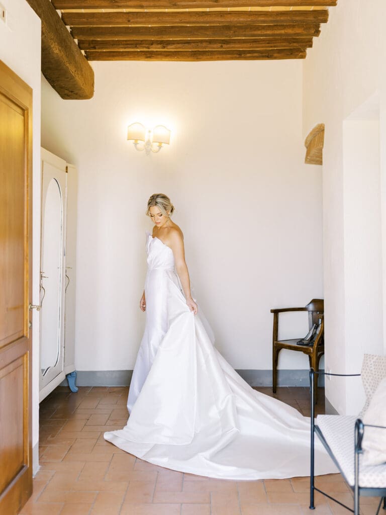Bridal portraits in her wedding dress during a summer wedding in Tuscany, Italy at Villa Petra