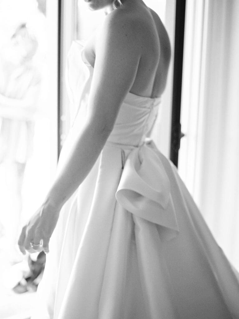 Black and white photo of a bride in her wedding dress. 