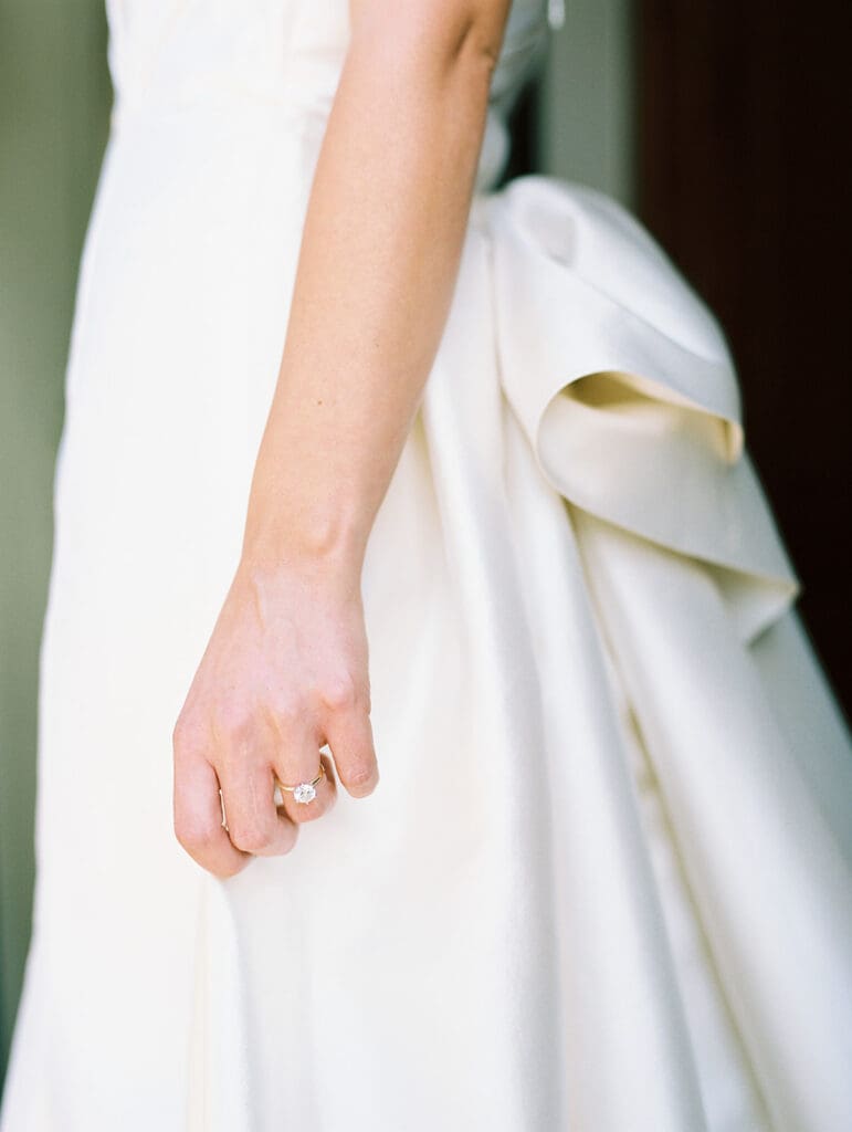 Close up shot of a brides hand with her wedding ring.