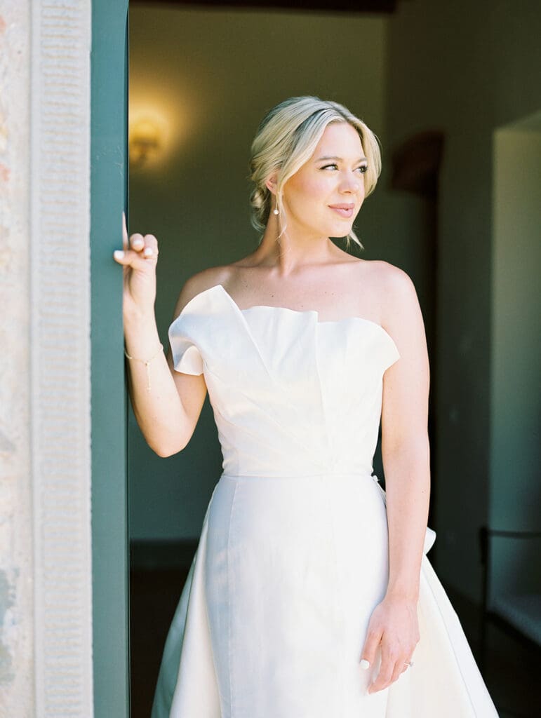 Bridal portraits in her wedding dress during a summer wedding in Tuscany, Italy at Villa Petra