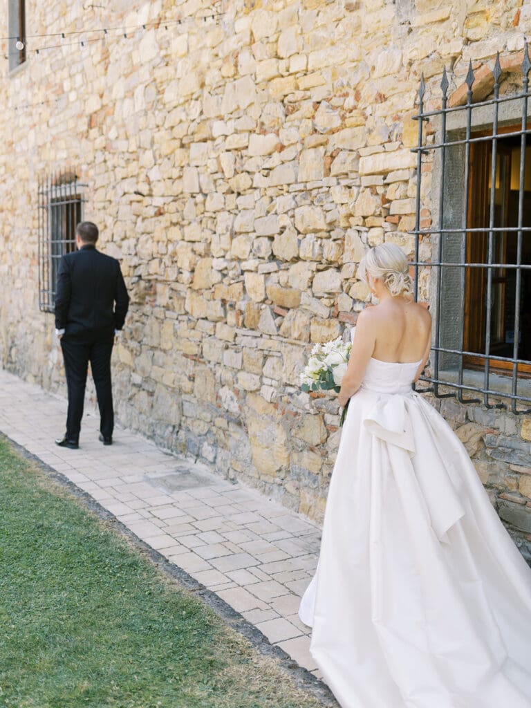 Bride and groom about to share their first looks from their summer wedding in Tuscany, Italy at Villa Petrea