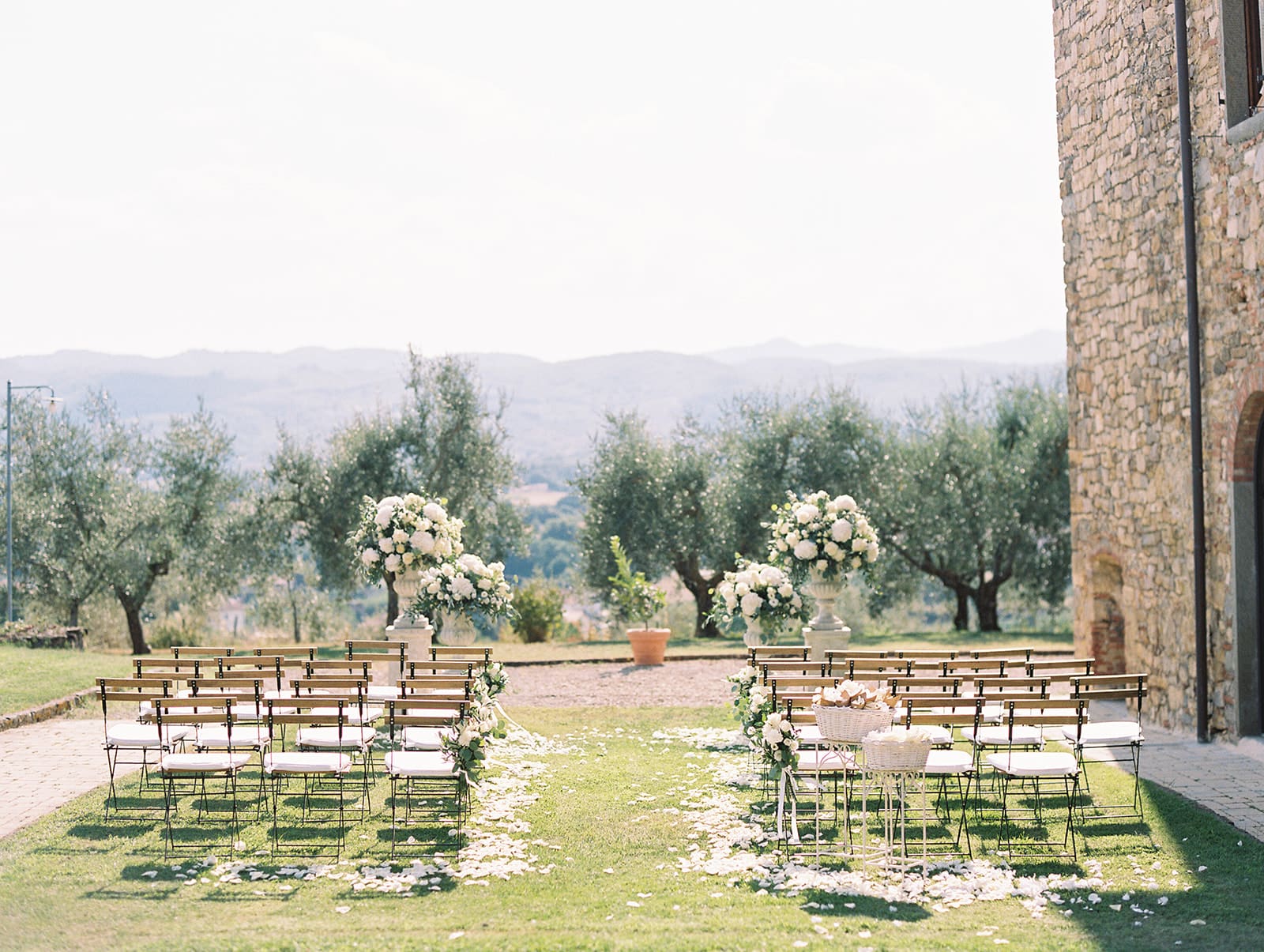 An outdoor summer wedding ceremony at Villa Petrea in the hills of Tuscany, Italy