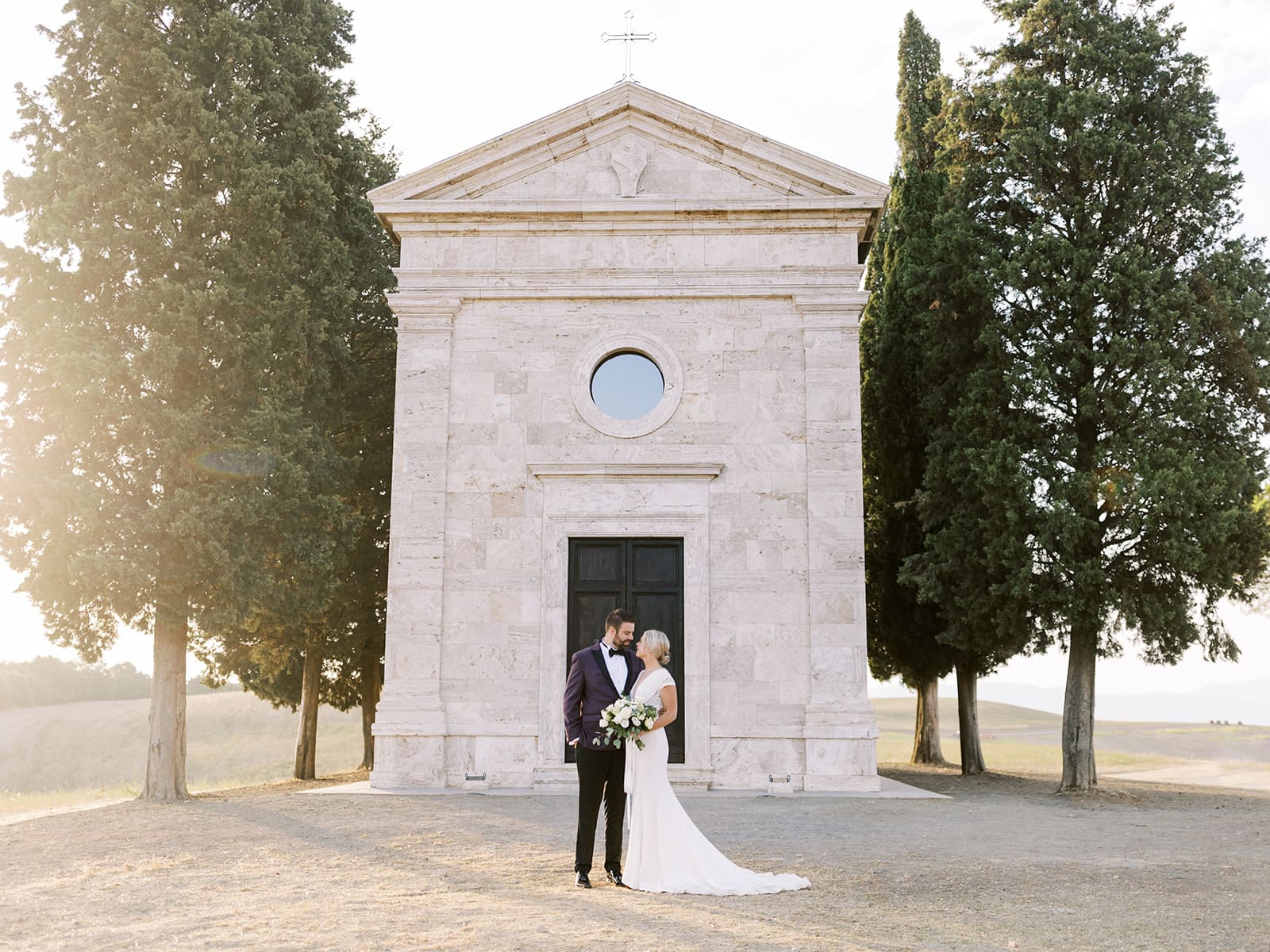 Sunrise bride and groom portraits at Chapel Vitalenta in Sienna, Italy