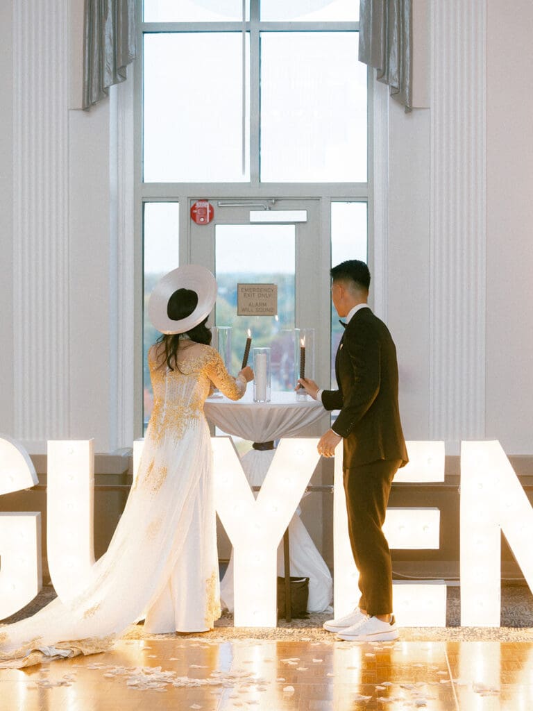Bride and groom performing a candle ritual during their reception